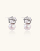 Gold-plated stud earrings with square crystal tops wrapped in twisted wire and freshwater pearl drops on white background