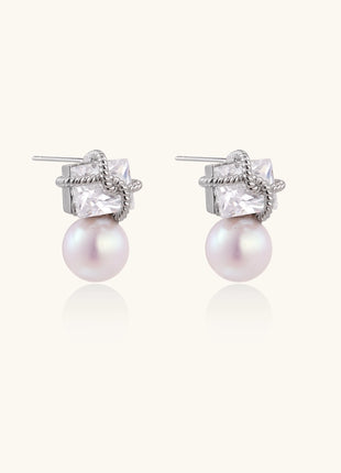 Gold-plated stud earrings with square crystal tops wrapped in twisted wire and freshwater pearl drops on white background