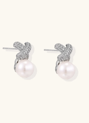 Elegant drop earrings with pavé crystal cross tops and round freshwater pearls on 14K gold plated brass setting.