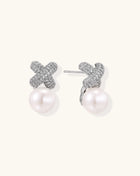Elegant drop earrings with pavé crystal cross tops and round freshwater pearls on 14K gold plated brass setting.