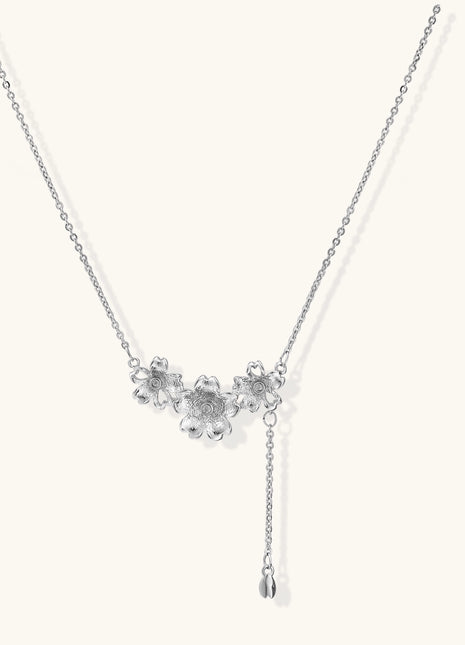 Delicate Y-style necklace with three textured flower pendants and adjustable chain in 14K gold plated brass finish.