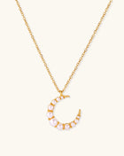 Delicate 18K gold plated necklace featuring crescent moon pendant with white shell pearl beads on neutral background.