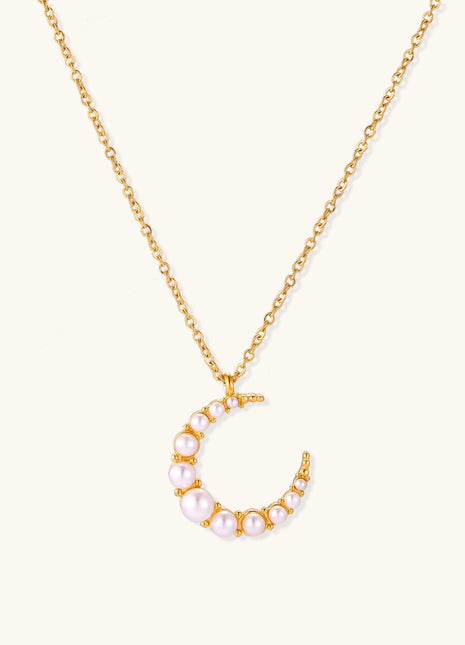 Delicate 18K gold plated necklace featuring crescent moon pendant with white shell pearl beads on neutral background.
