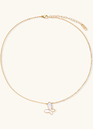 Delicate gold butterfly necklace with white mother of pearl wings on fine chain, displayed on neutral background.