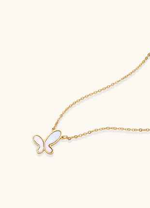 Delicate gold butterfly necklace with white mother of pearl wings on fine chain, displayed on neutral background.
