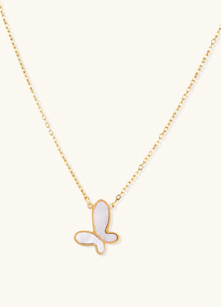 Delicate gold butterfly necklace with white mother of pearl wings on fine chain, displayed on neutral background.