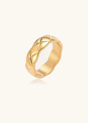 18K gold plated stainless steel ring with geometric twisted band design on neutral background