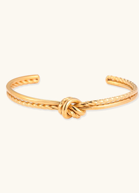 18K gold-plated twisted rope cuff bracelet with decorative knot detail on white background, showing adjustable open design.