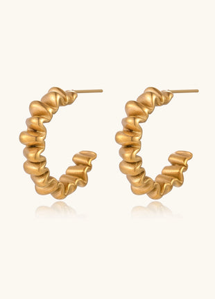 Gold-plated stainless steel earrings with twisted rope texture in various hoop sizes on neutral background.