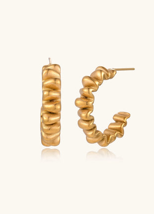 Gold-plated stainless steel earrings with twisted rope texture in various hoop sizes on neutral background.