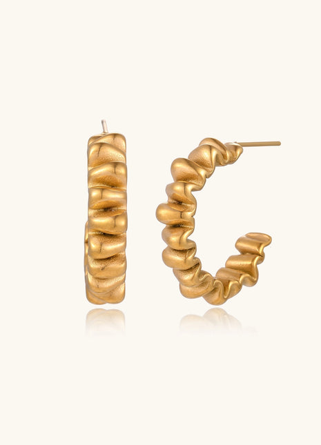 Gold-plated stainless steel earrings with twisted rope texture in various hoop sizes on neutral background.