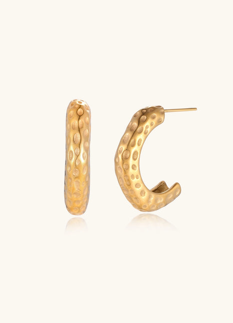 Textured gold-plated hoop earrings with dimpled surface pattern and post backs on neutral background.
