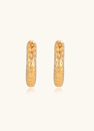 Textured gold-plated hoop earrings with dimpled surface pattern and post backs on neutral background.
