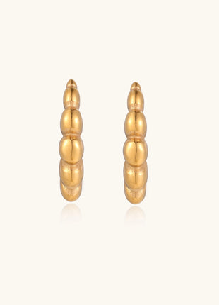 Gold-plated stainless steel hoop earrings with segmented bubble design and post closure on white background