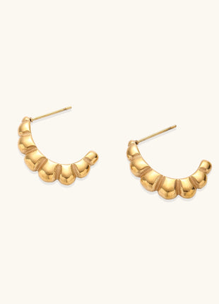 Gold-plated stainless steel hoop earrings with segmented bubble design and post closure on white background