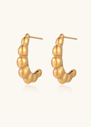Gold-plated stainless steel hoop earrings with segmented bubble design and post closure on white background