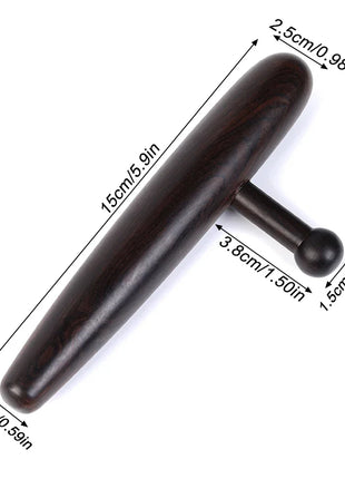 Massage stick placed next to essential oils