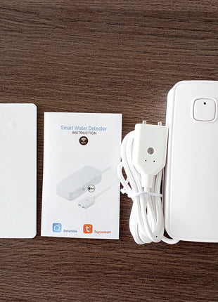 Smart WiFi water sensor operating next to drain pipe